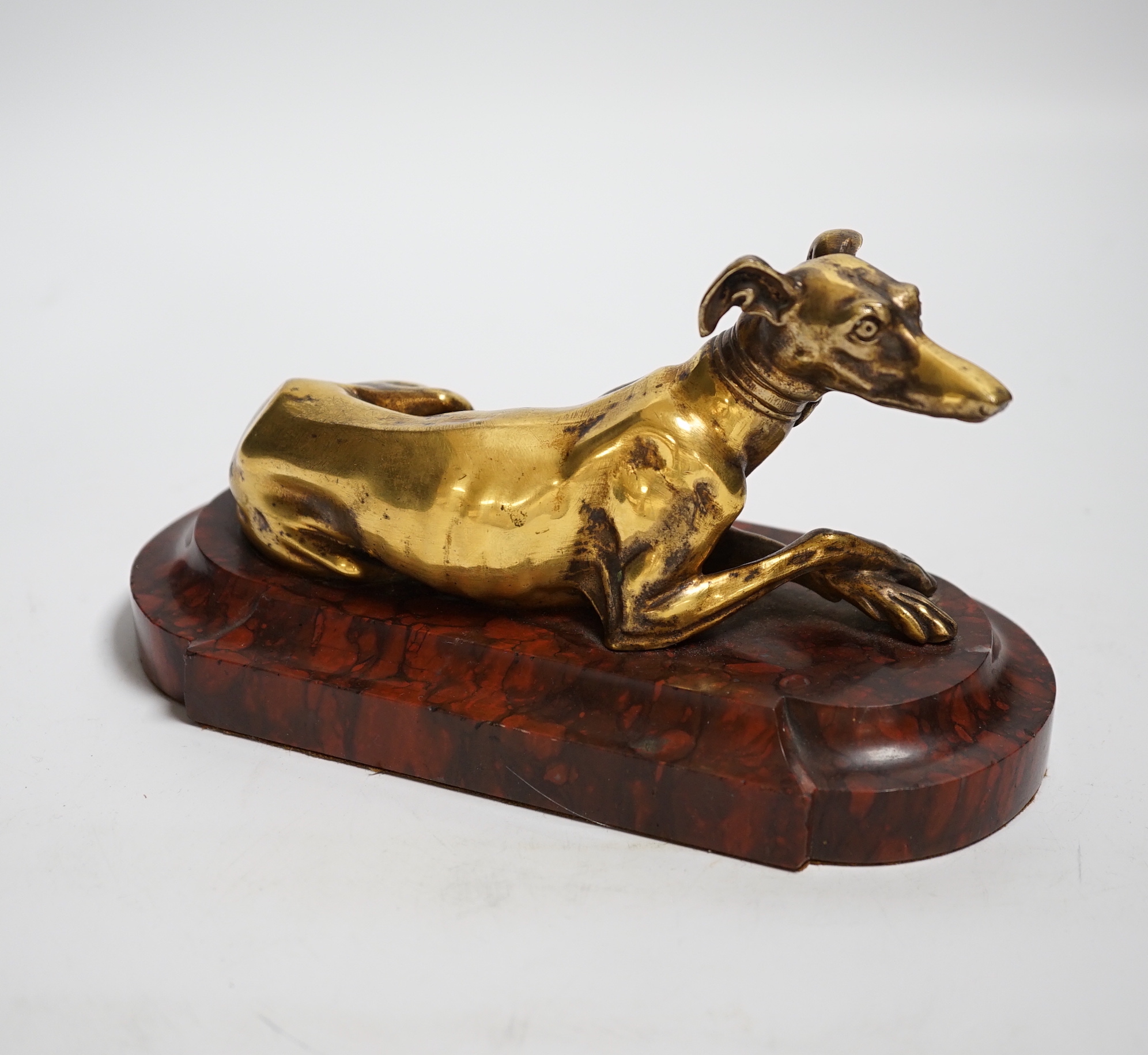 A 19th century French gilt bronze of model of a recumbent greyhound on a rouge marble plinth, 19cm wide